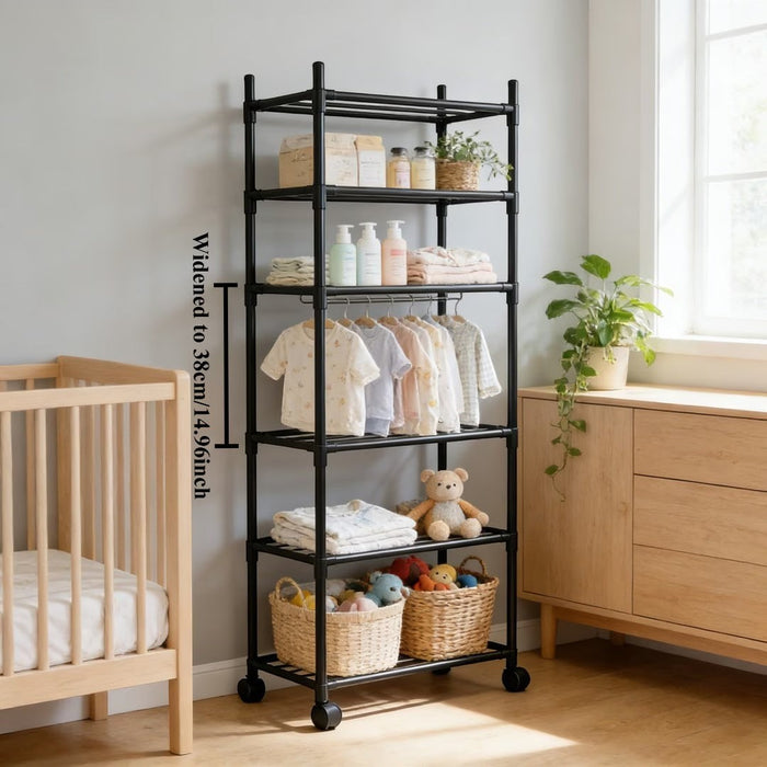 Blessing Sells black 6-layer wheeled storage rack with adjustable shelves holding baby clothes, bottles, and toys. Next to a crib and dresser.