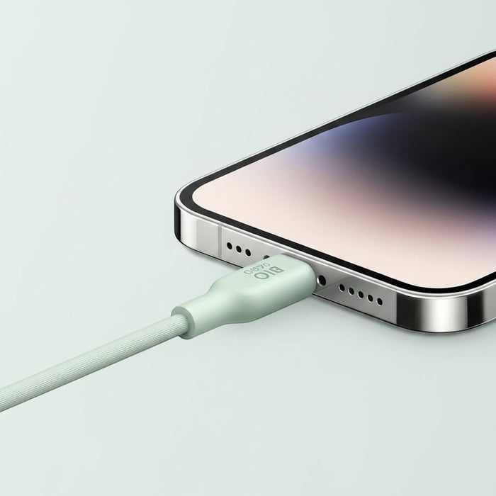 Blessing Sells light green braided bio-based charging cable plugged into an iPhone.