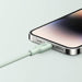 Blessing Sells light green braided bio-based charging cable plugged into an iPhone.