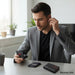 Blessing Sells black wireless earbuds with red accents, shown with charging case and phone.