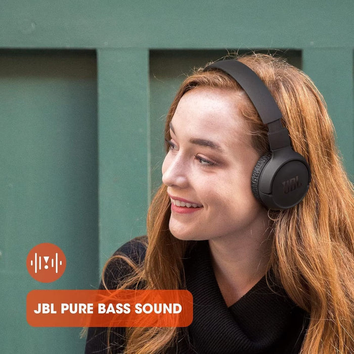 Blessing Sells woman wearing black JBL Tune 510BT wireless on-ear headphones with pure bass sound.
