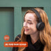 Blessing Sells woman wearing black JBL Tune 510BT wireless on-ear headphones with pure bass sound.