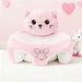 Blessing Sells pink plush toddler seat shaped like a cat with embroidered bow. Supports baby learning to sit.