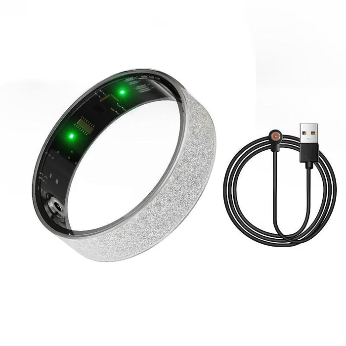 Blessing Sells smart ring with diamond inlay, silver glitter band, green LED lights, and USB charging cable.
