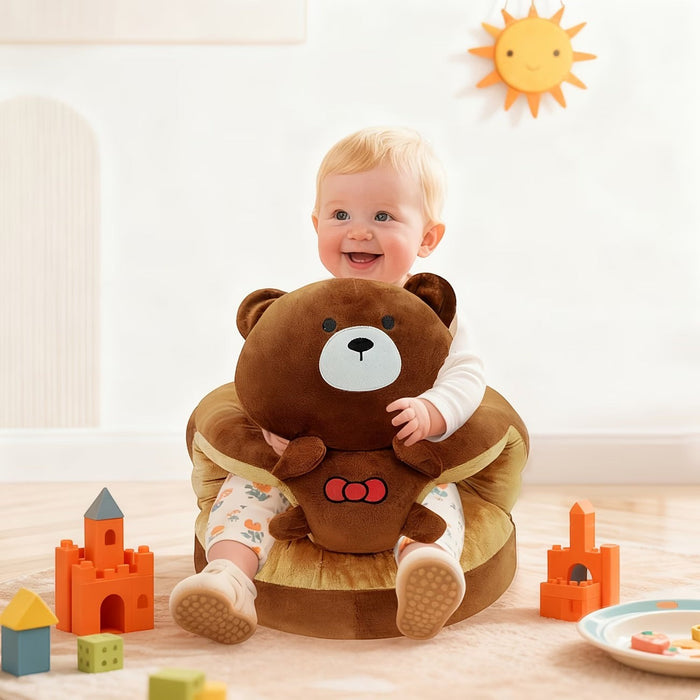 Blessing Sells brown plush toddler seat shaped like a teddy bear, with a happy baby sitting in it.