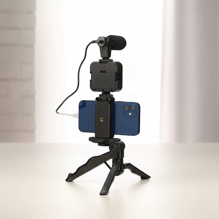 Blessing Sells smartphone vlogging kit with microphone, LED light, and mini tripod, holding a blue iPhone.