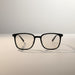 Blessing Sells unisex matte black full-frame smart glasses with photosensitive, anti-blue light lenses.